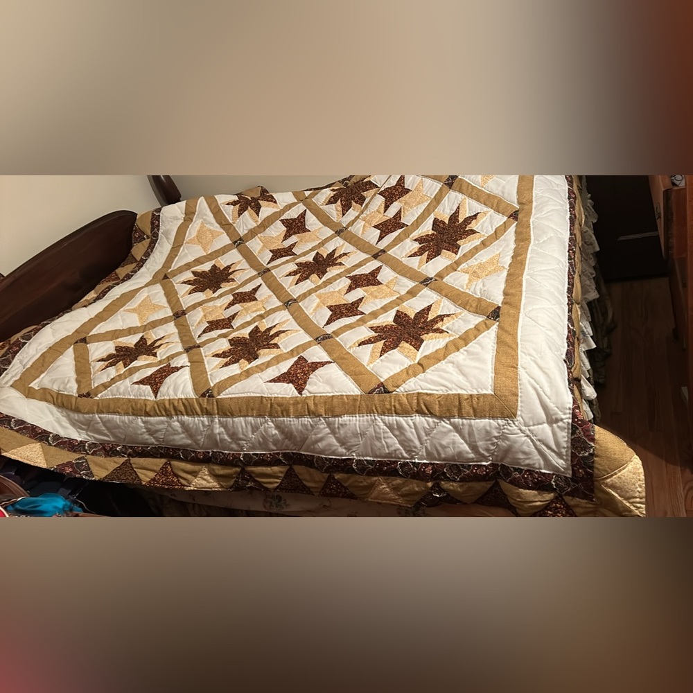 Patchwork hand sewn cotton quilt featuring an autumn themed star pattern queen